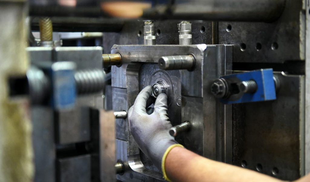 Workman working on large industrial machinery